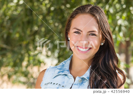 Attractive Smiling Mixed Race Girl Portrait Outdoors Attractive Smiling Mixed Race Girl Portrait Outdoors 42556940