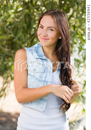 Attractive Smiling Mixed Race Girl Portrait Outdoors Attractive Smiling Mixed Race Girl Portrait Outdoors 42556941