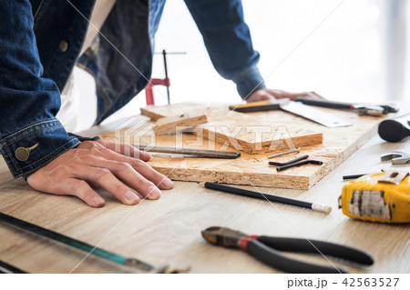Carpenter working carefully looking at the plans work in carpent 42563527