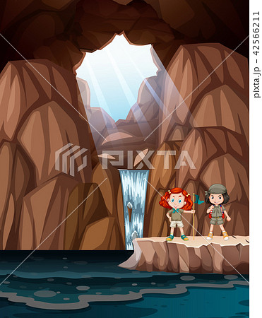 Girls exploring a cave with waterfall Girls exploring a cave with waterfall 42566211
