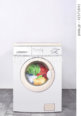 Dirty clothes washed on washing machine Dirty clothes washed on washing machine 42571641