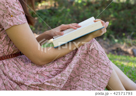 Young woman reading bible in natural park 42571793