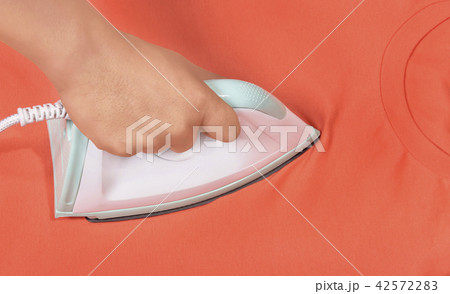 Man hand ironing colored clothes Man hand ironing colored clothes 42572283