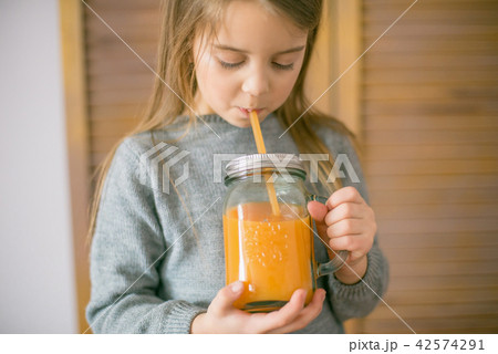 Cute little girl with glass of orange juice  42574291