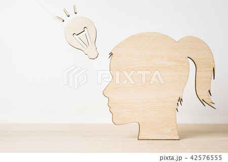 wooden girl silhouette head with idea lightbulb 42576555