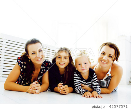 Mature sisters twins at home with little daughter, happy family  42577571