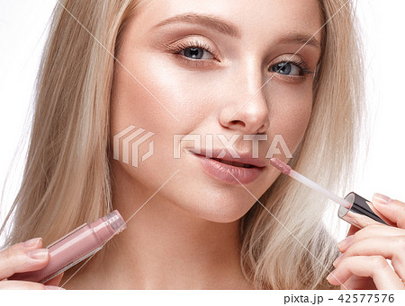 Beautiful young girl with a light natural make-up, lipstick and nude manicure. Beauty face. Beautiful young girl with a light natural make-up, lipstick and nude manicure. Beauty face. 42577576