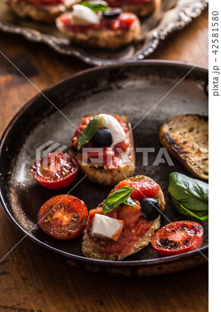 Bruschetta toast with mozzarella tomatoes olives 42581580