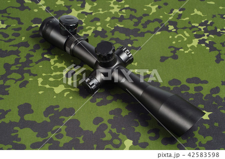 sniper scope on camouflage background 42583598