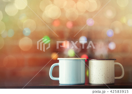 two Hot cups of coffee with fairy lights 42583915