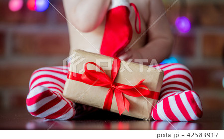 baby boy in elf hat with gift box  42583917