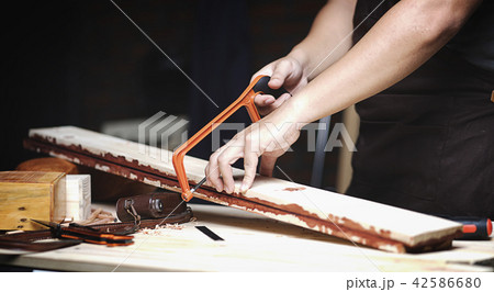 Carpenter Working in Woodworking Workshop 42586680