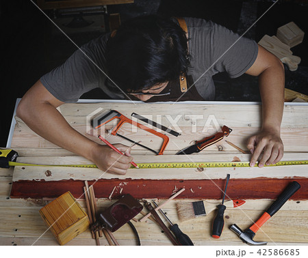Top View of Asian Carpenter Working in Woodworking 42586685