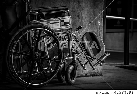 Wheelchair folded beside the wall. Hospital scene 42588292