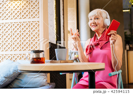 Nice aged woman listening to music Nice aged woman listening to music 42594115