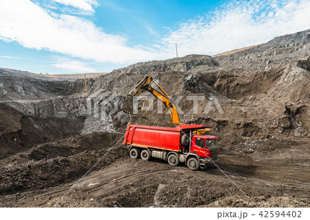 Large quarry dump truck. Loading the rock in dumper. Loading coal into body truck. Production useful Large quarry dump truck. Loading the rock in dumper. Loading coal into body truck. Production useful 42594402