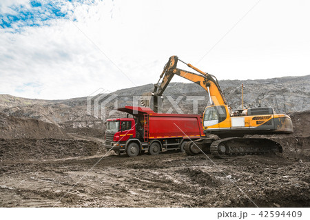 Large quarry dump truck. Loading the rock in dumper. Loading coal into body truck. Production useful 42594409