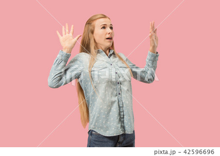 Portrait of the scared woman on pink 42596696