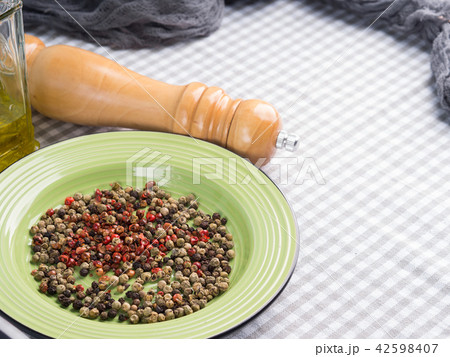 Mix of peppercorns in a green dish Mix of peppercorns in a green dish 42598407