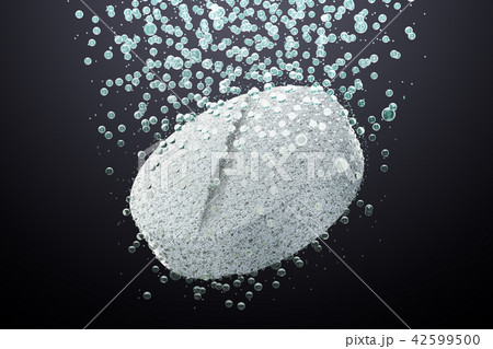 Effervescent soluble tablet pill in water on dark 42599500