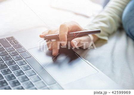 Young woman hold pen and searching internet 42599969