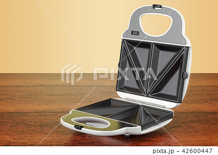 Opened sandwich maker on the wooden table 42600447