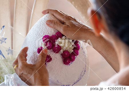 Woman Crafting a Pedestal Flowers Tray. 42600854