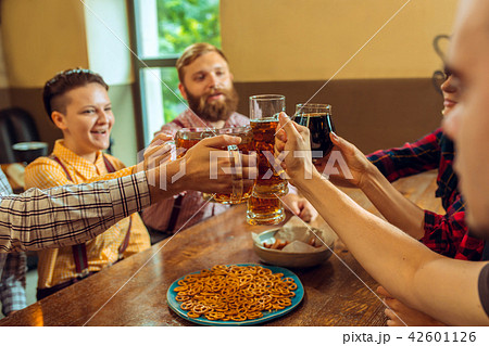 people, leisure, friendship and communication concept - happy friends drinking beer, talking and people, leisure, friendship and communication concept - happy friends drinking beer, talking and 42601126