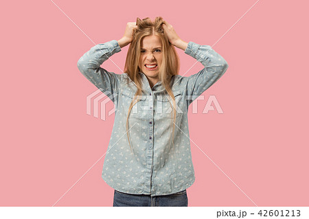 Portrait of an angry woman looking at camera isolated on a pink background 42601213