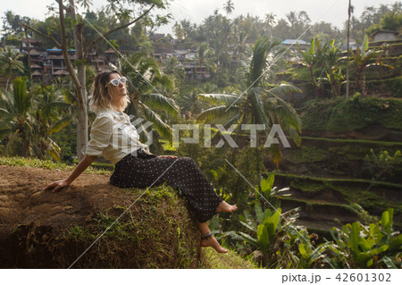 Young woman traveling enjoying rice field in Bali Young woman traveling enjoying rice field in Bali 42601302