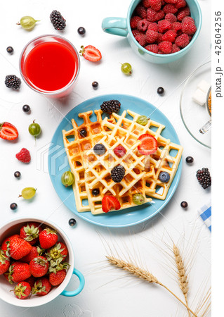 Photo of Viennese waffles,, coffee, raspberries, strawberries, gooseberries, cherries 42604256