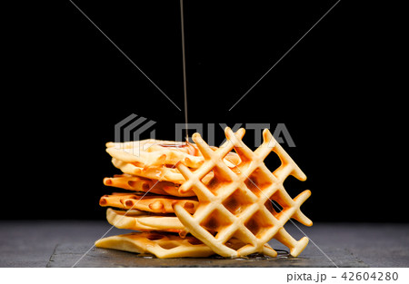 Photo of Viennese wafers with honey on an black background Photo of Viennese wafers with honey on an black background 42604280