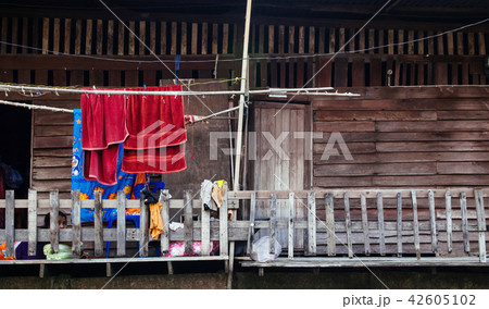 Thai old wooden house hanging colourful clothes Thai old wooden house hanging colourful clothes 42605102