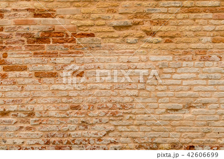 Old and damaged brown brick wall 42606699