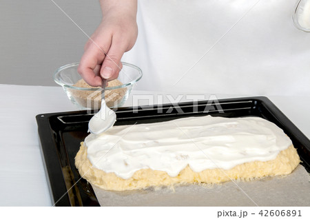 Black baking tray covered with baking paper 42606891