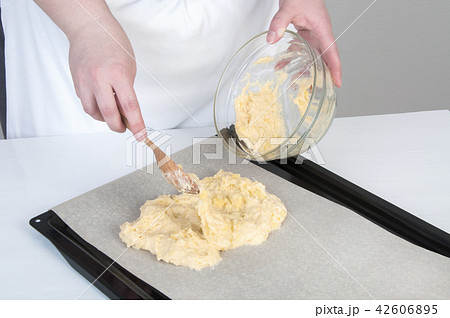 Black baking tray covered with baking paper Black baking tray covered with baking paper 42606895