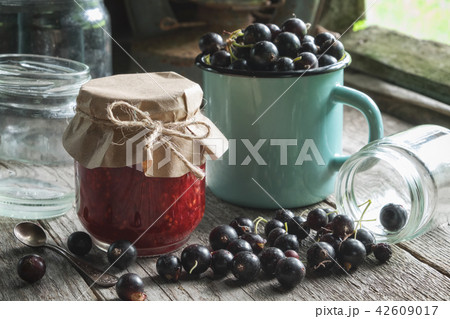 Black currants jam, enameled mug of black currants 42609017
