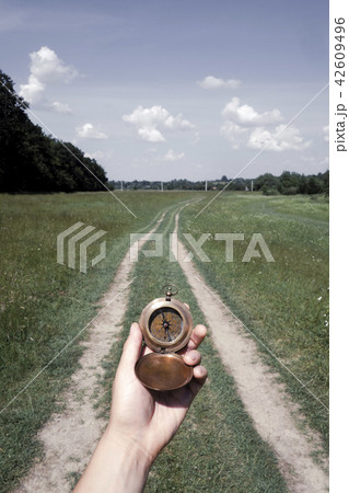 Man with compass in hand 42609496
