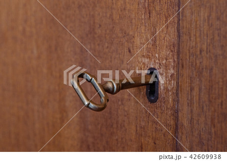 Old wooden cabinet with vintage key 42609938