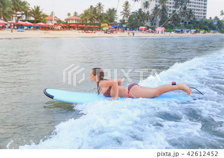 girl surfing in the ocean 42612452
