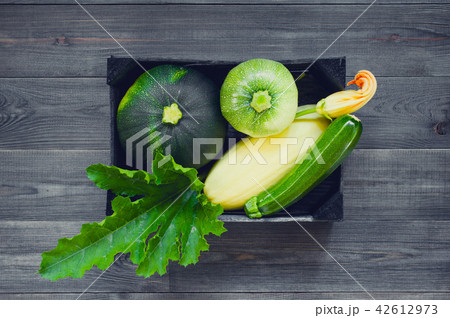 Dark composition with zucchini and squashes 42612973