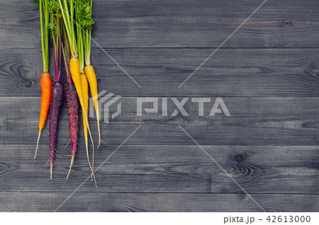 Bright colorful carrots on the wooden table Bright colorful carrots on the wooden table 42613000