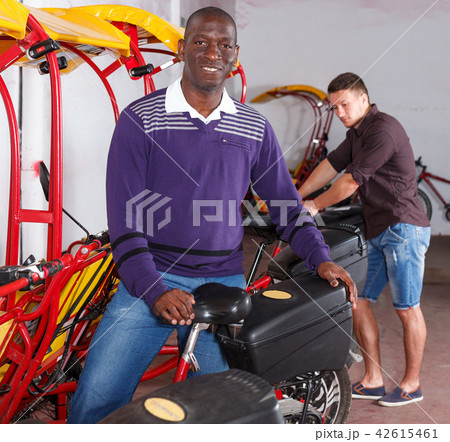 African-American man offering cycle rickshaw service African-American man offering cycle rickshaw service 42615461