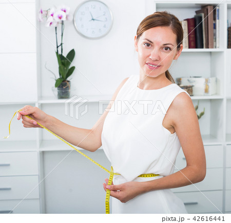 woman with measuring tape around waist 42616441