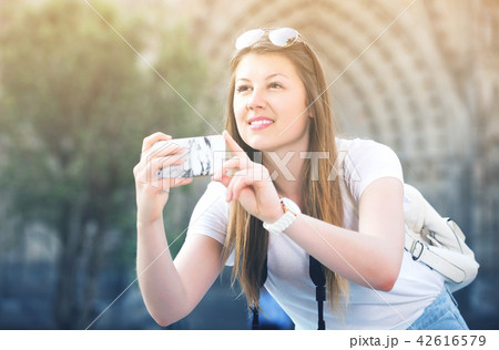 Girl holding phone and photographing Girl holding phone and photographing 42616579