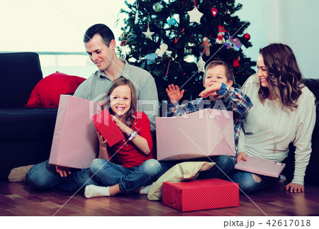 Large happy family handing gifts during Christmas at home 42617018