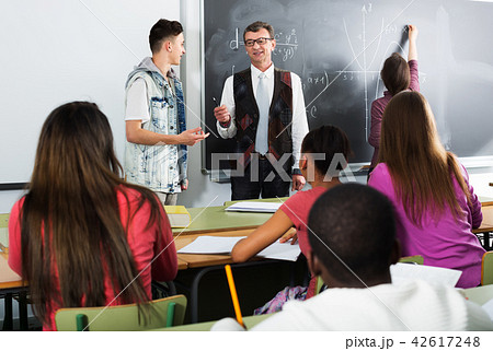 Students and teacher in class Students and teacher in class 42617248