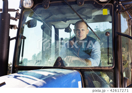 Portrait of confident male owner of vineyard behind glass in tra Portrait of confident male owner of vineyard behind glass in tra 42617271