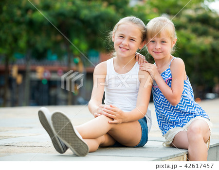 Two smiling little girls embracing Two smiling little girls embracing 42617457