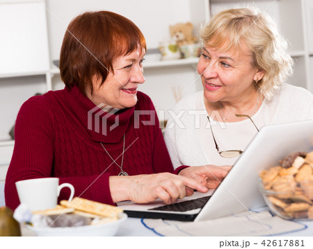 Two happy senior women using laptop Two happy senior women using laptop 42617881